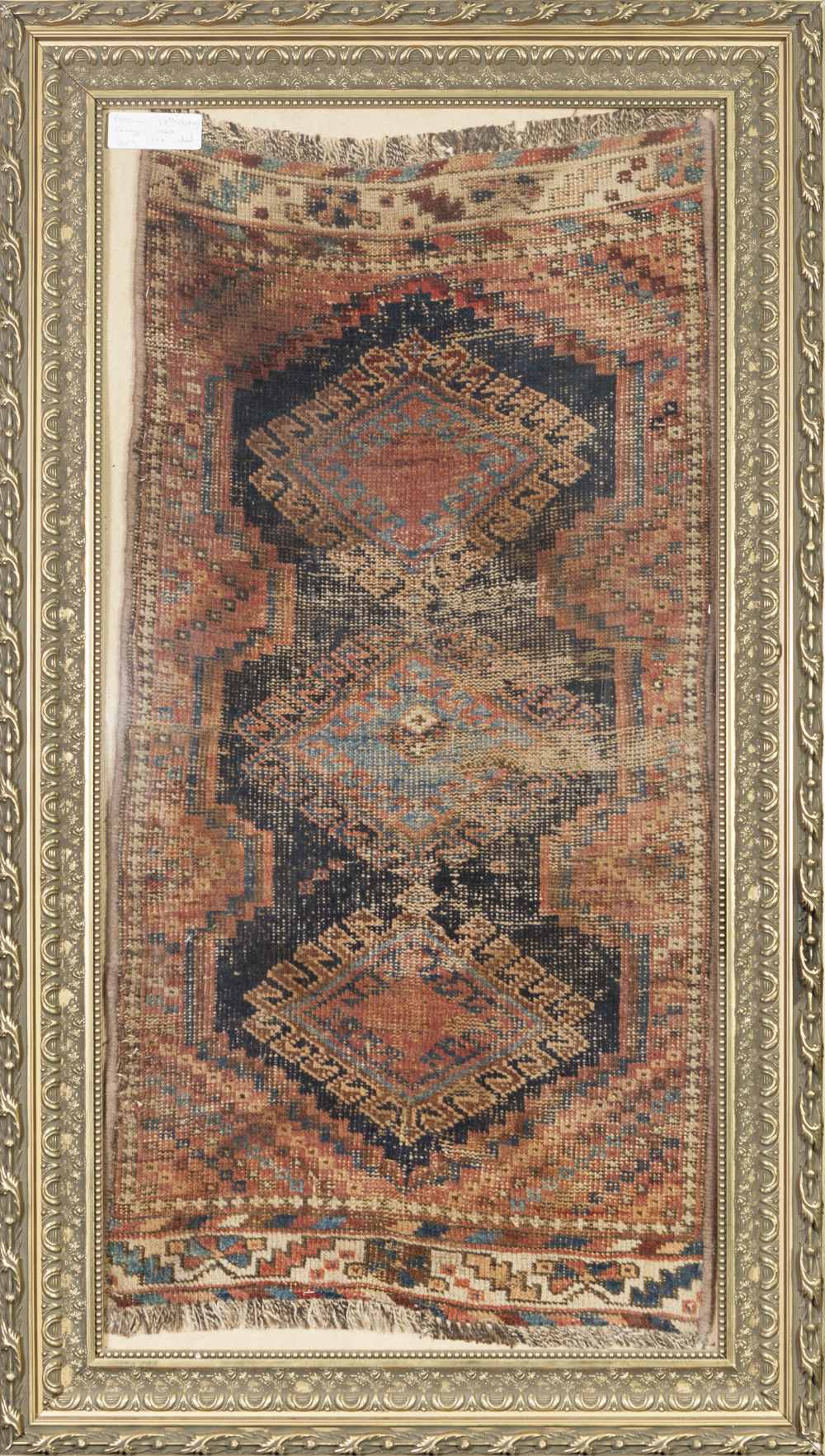 PERSIAN ANTIQUE RUG, with triple diamond shaped pole medallions with latch hook border in pink and