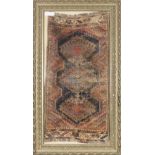 PERSIAN ANTIQUE RUG, with triple diamond shaped pole medallions with latch hook border in pink and