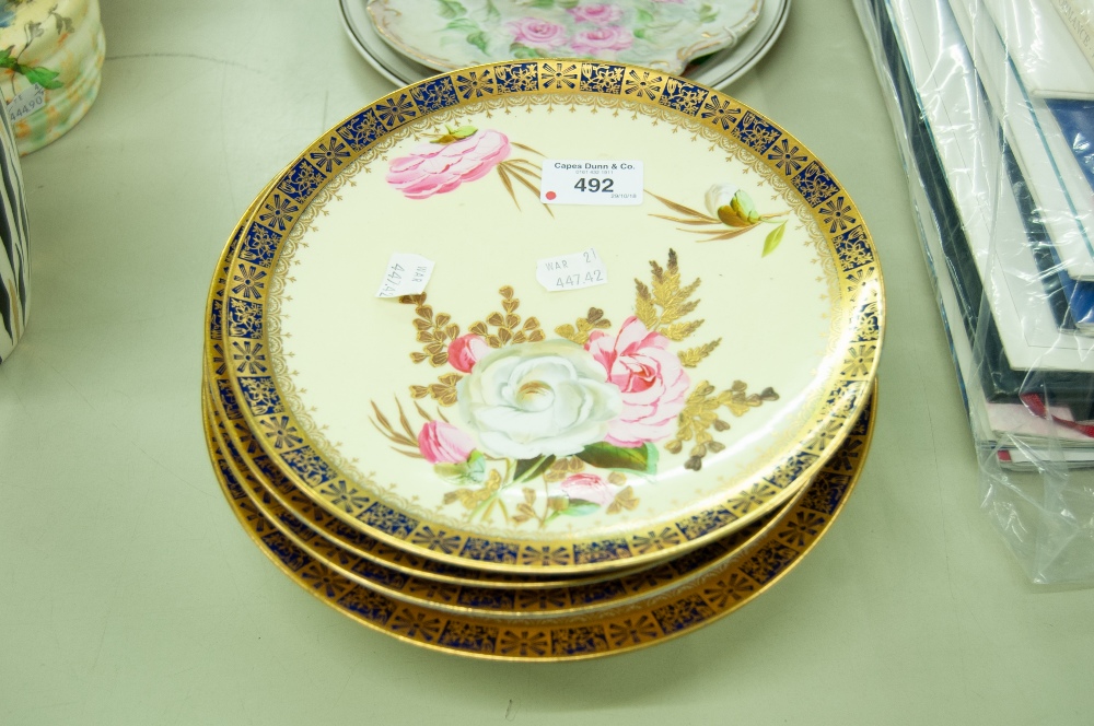 A SET OF EARLY TWENTIETH CENTURY PAINTED DESSERT PLATES WITH YELLOW GROUND AND HAND PAINTED FLOWERS,