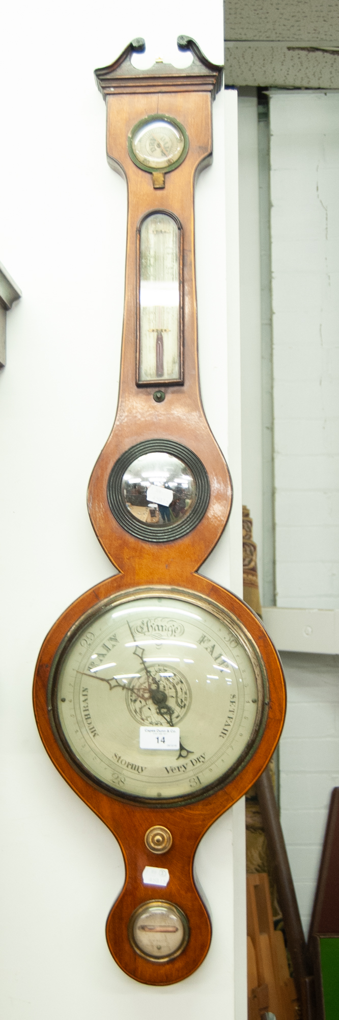 AN ANTIQUE WHEEL BAROMETER WITH SILVERED DIAL, BROKEN ARCH PEDIMENT OVER HYDROMETER, THERMOMETER