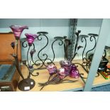 PAIR OF BLACK WROUGHT IRON PLANT FORM THREE LIGHT CANDELABRA WITH PURPLE GLASS SCONCES AND THE