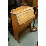 CIRCA 1920S OAK BUREAU OVER OPEN BOOK SHELVES, THE FALL FRONT WITH BEAD AND BAR DECORATION AND AN