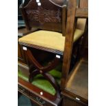 A MAHOGANY 'X' FRAME STOOL COVERED IN GOLD VELVET