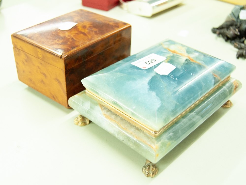 AN ONYX TABLE CIGARETTE BOX AND A WALNUTWOOD MUSICAL BOX