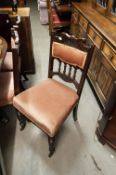 A SET OF FOUR MAHOGANY DINING CHAIRS, WITH OVERSTUFFED SEATS, RAIL AND CUSHION BACK SUPPORTS