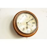 AN EARLY TWENTIETH CENTURY OAK CIRCULAR WALL CLOCK 'A.E.C.'