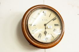 AN EARLY TWENTIETH CENTURY OAK CIRCULAR WALL CLOCK 'A.E.C.'