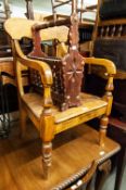 A VICTORIAN HARDWOOD COMMODE ARMCHAIR AND A STAINED WOOD PERIODICAL RACK