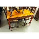 A REPRODUCTION OF FRENCH WRITING TABLE, WITH SHAPED TOP OVER SINGLE DRAWERS, ALL RAISED ON