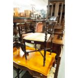 A VICTORIAN CORNER CHAIR, HAVING SHAPED TOP RAIL OVER PIERCED BACK SPLATS, PAD SEAT WITH STRIPED