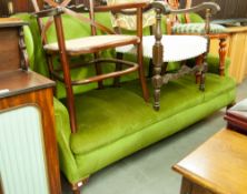 A LARGE GREEN VELOUR COVERED WINGED BACK SETTEE ON SHORT CABRIOLE FORELEGS