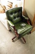 A REPRODUCTION CAPTAIN'S CHAIR, BUTTON PAD BACK, SEAT AND ARMS, UPHOLSTERED IN GREEN HIDE, ON FIVE