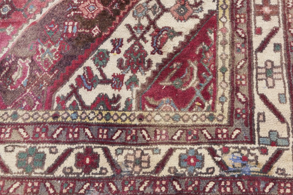 EASTERN CARPET, with diamond shaped white medallion with pendants on a red and herati field with - Image 2 of 2