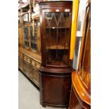 A REPRODUCTION MAHOGANY STANDING CORNER CUPBOARD