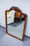 AN EDWARDIAN MAHOGANY SHAPED WALL MIRROR