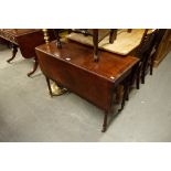 A REGENCY MAHOGANY OBLONG FALL LEAF DINING TABLE ON FOUR SLENDER TURNED TAPERING LEGS WITH CASTORS