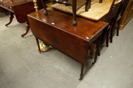 A REGENCY MAHOGANY OBLONG FALL LEAF DINING TABLE ON FOUR SLENDER TURNED TAPERING LEGS WITH CASTORS