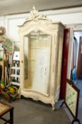 A LARGE FRENCH STYLE CREAM PAINTED DISPLAY CABINET WITH GLASS SHELVES AND LARGE GLAZED DOOR, WITH