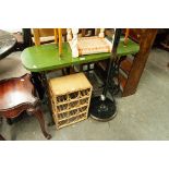 A CANE SMALL TWELVE BOTTLE WINE RACK, AND A GREEN PAINTED SIDE TABLE ON CAST IRON BASE