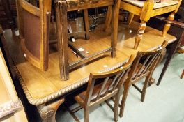 A MAHOGANY OBLONG DINING TABLE, ON CABRIOLE SUPPORTS WITH CLAW AND BALL FEET AND CASTORS,