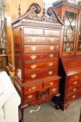 A REPRODUCTION MAHOGANY CHEST ON STAND, PIERCED AND SHAPED PEDIMENT OVER TWO SHORT AND FIVE LONG