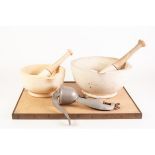 TWO GRADUATED STONEWARE MORTARS with wooden handled pestles, also a TABLE SECURED MINCER and a brass