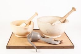 TWO GRADUATED STONEWARE MORTARS with wooden handled pestles, also a TABLE SECURED MINCER and a brass