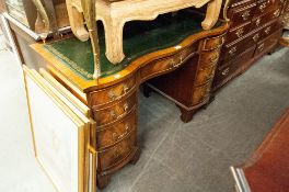 A REPRODUCTION PEDESTAL SERPENTINE KNEEHOLE DESK, WITH GREEN LEATHER INSET TOP, OVER CENTRAL DRAWER,