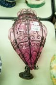 A PUCE TINTED GLASS METAL BOUND HANGING CEILING LIGHT WITH ROSE