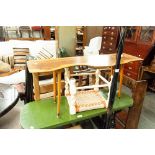 AN OAK FOUR TIER OPEN BOOKCASE, 2'6" WIDE AND A 1960S ELM COFFEE TABLE, ON 'T.V.' LEGS (2)