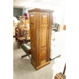 A DISGUISED OAK GUN CABINET, WITH GREEN BAIZE LINING TO ACCOMMODATE SEVEN SHOTGUNS