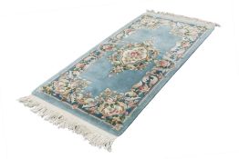 WASHED CHINESE EMBOSSED ALL WOOL RUG OF AUBUSSON DESIGN, with centre floral medallion and surround