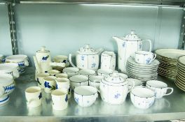 A CZECHOSLOVAKIAN TEA SERVICE FOR SIX PERSONS, ANOTHER FOR TWELVE PERSONS WITH BLUE FLORAL DETAIL