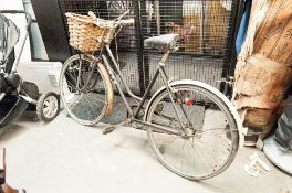 A LADY'S PUCH BICYCLE WITH SHOPPING BASKET