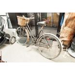 A LADY'S PUCH BICYCLE WITH SHOPPING BASKET