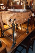 TWO BLACK CAST IRON FRAMED OBLONG STOOLS WITH WOVEN CANE SEATS