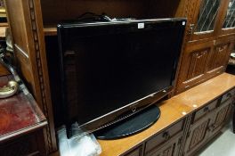 MODERN SAMSUNG FLAT SCREEN TELEVISION WITH REMOTE CONTROL AND POWER LEAD