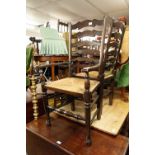 A PAIR OF REPRODUCTION OAK CARVED CHAIRS, LADDER BACKS WITH RUSH SEATS (2)