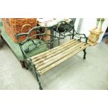 A GREEN PAINTED CAST IRON ENTWINED BRANCH PATTERN AND SLATTED WOOD GARDEN BENCH
