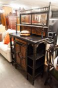 AN ARTS AND CRAFTS EBONISED DECORATED SIDE CABINET, WITH RAISED MIRROR BACK