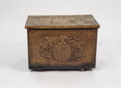 AN EARLY 20TH CENTURY BRASS EMBOSSED COAL BOX, depicting heraldic emblem to the top, with metal