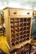 A MODERN PINE WINE RACK WITH DRAWER ABOVE