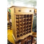 A MODERN PINE WINE RACK WITH DRAWER ABOVE