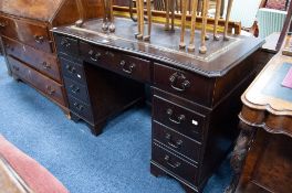 MODERN REPRODUCTION DARK OAK TWIN PEDESTAL DESK, with gilt tooled 'antique' brown leather inset top,