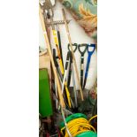 A COLLECTION OF GARDEN TOOLS TO INCLUDE RAKES, FORKS, SPADES ETC...