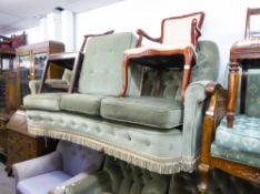 A LOUNGE SUITE OF THREE PIECES, BUTTON UPHOLSTERED IN GREEN VELVET AND A SQUARE FOOTSTOOL