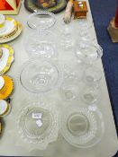 A COLLECTION OF GLASS TABLE WARES TO INCLUDE; PATES, BOWLS WITH BEAD RIM DETAIL, FRUIT BOWL,, JUG