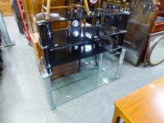 A PLATE GLASS THREE TIER OBLONG COFFEE TABLE/TV STAND, ON GREY METAL SUPPORTS AND A BLACK GLASS