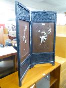 AN ORIENTAL BLACK AND LACQUERED TWO-FOLD LOW SCREEN WITH BONE AND MOTHER OF PEARL APPLIED