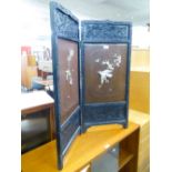 AN ORIENTAL BLACK AND LACQUERED TWO-FOLD LOW SCREEN WITH BONE AND MOTHER OF PEARL APPLIED